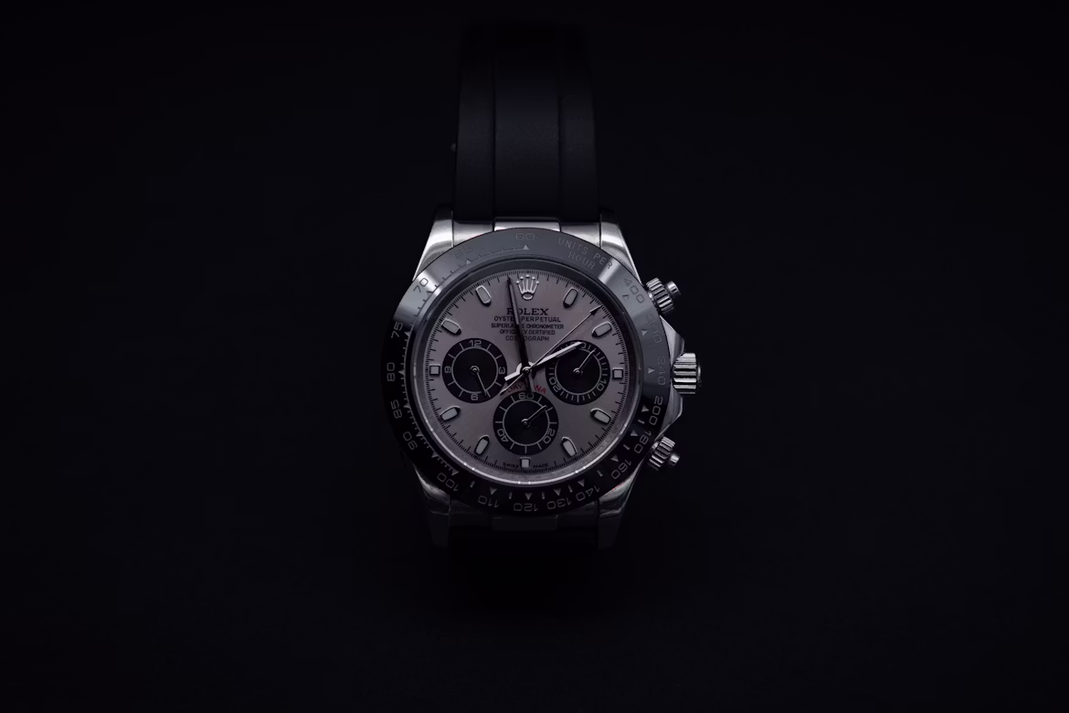 Luxury rose-gold chronograph watch on a dark polished surface